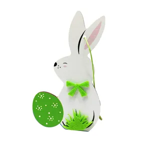 Minimalist wooden Easter bunny ornament holding a green polka dot egg for home decor