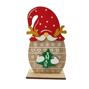 Handcrafted wooden Christmas gnome ornament with red hat and Xmas tree on a stable base