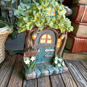 Detailed resin fairy tree house with blue door and Welcome sign for garden decor