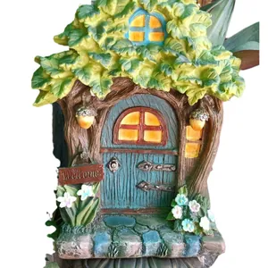 Fairy tree house garden statue with green leaves and a welcome sign ornament