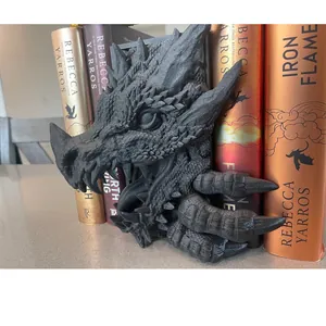 Détail des serre-livres dragon en résine noire mate montrant la texture des écailles