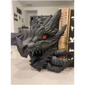 Gros plan d'un serre-livres dragon en résine noire avec des yeux rouges et écailles