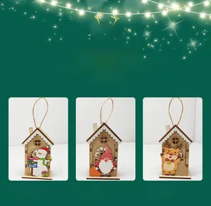 Three illuminated Christmas wooden houses featuring snowman and Santa Claus designs