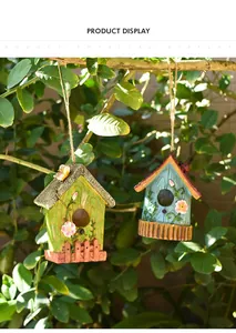 Detail of hanging birdhouse ornaments with floral patterns and rustic hemp ropes