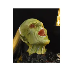 Detailed view of scary green zombie figurine with long hair and open mouth scream