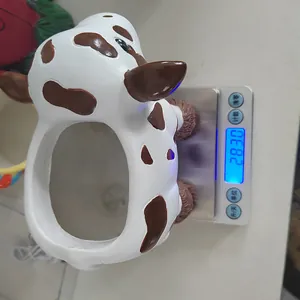 Detailed top view of a resin cow succulent planter being weighed on a digital scale