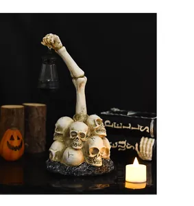 Detailed view of resin zombie hand holding a vintage lantern atop a skull base