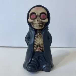 Chibi Reaper skeleton figurine with black hooded cloak and red eyes decor
