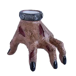 Creepy resin zombie hand candle holder with skull detail for Halloween garden decor
