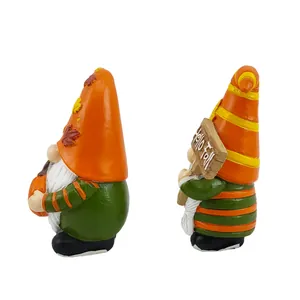 Detail showing two autumn gnomes with Hello Fall sign and pumpkin on white background