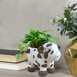Cute cow resin succulent planter on wooden shelf for indoor and outdoor garden decoration
