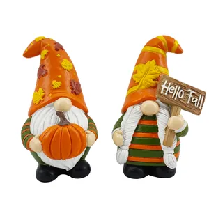 Detail of harvest gnomes with pumpkin and Hello Fall sign in warm autumn colors