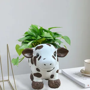 Cute cow shaped resin succulent planter pot with green plants for home and garden decor