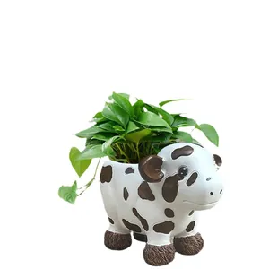 Cute cow shaped resin flower pot with black spots for indoor plants and garden decor