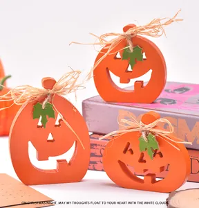 Three handcrafted wooden Jack-o'-lantern ornaments with raffia bows for Halloween decor