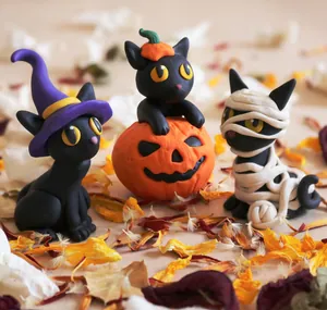 Three Halloween resin black cat figurines featuring witch, pumpkin, and mummy designs