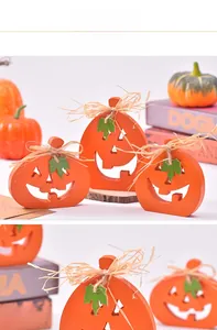 Three-piece wooden Halloween pumpkin ornaments with raffia bows and cutout faces