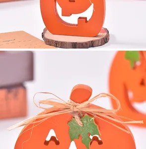Detail of wooden pumpkin ornament with raffia bow and leaf for Halloween table decor
