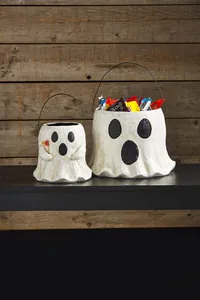 Ghost Halloween treat buckets set with Boo flag and black wire handles on wood surface