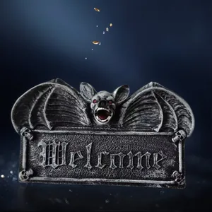 Gothic resin bat welcome sign with red eyes and skull details for Halloween decor