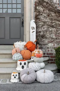 Halloween paper mache treat bucket and fabric pumpkins display on a vintage doorstep