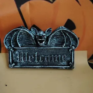 Detailed view of Gothic bat wall hanging with Welcome sign and red eyes for Halloween