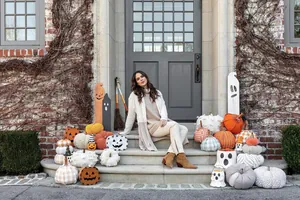 Outdoor Halloween porch decor with paper mache ghost and pumpkin treat buckets
