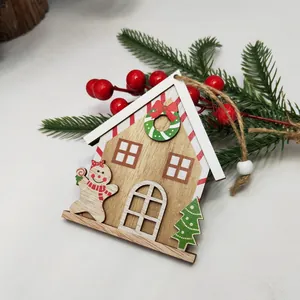 Christmas wooden gingerbread house ornament with a cute gingerbread man and festive decor