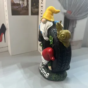 Garden gnome resin ornament with a tire, golden snail, and white Welcome sign detail