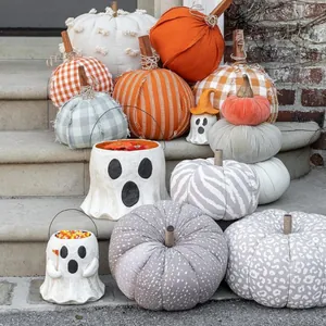 Halloween paper mache treat buckets and decorative fabric pumpkins on stone steps