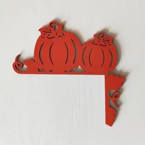 Detailed view of laser-cut red pumpkin door frame corner decor for Halloween