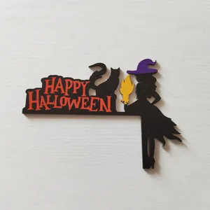 Detail of wooden Halloween door corner decor featuring a black witch, cat and red text