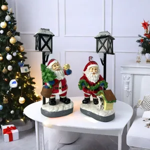 Detail of resin Santa Claus figurines with glowing street lamps and Welcome signs