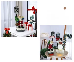 Detailed view of resin Santa and Snowman figurines with a glowing welcome lamp post