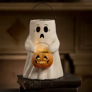 Halloween ghost holding a pumpkin lantern ornament on vintage books with warm glowing light