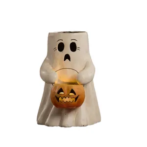 Ghost figurine holding glowing pumpkin lamp for Halloween desktop decoration
