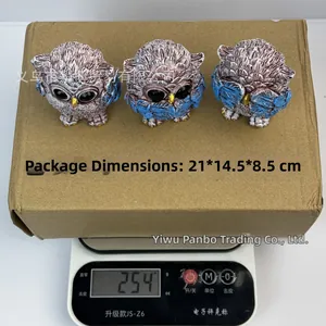 Three-piece owl resin figurines set on scale showing weight 254g and 21x14.5x8.5cm box size
