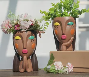 Artistic resin girl face flower pot with colorful makeup and closed eyes detail