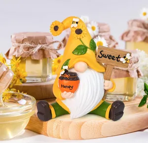 Detail of resin bee gnome figurine with Honey pot and Sweet sign for garden decor