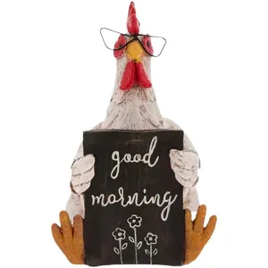 Close-up of resin rooster statue with glasses holding a Good Morning sign on white background