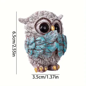 Retro owl resin statue in speak-no-evil pose with blue wings and gold accents