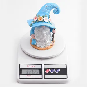 Detailed view of a resin Christmas garden gnome on a scale weighing 326.5 grams
