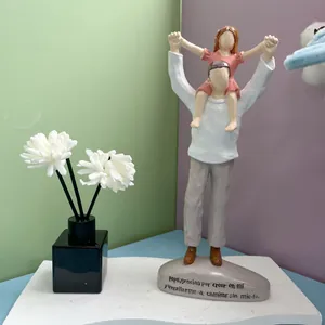 Detail of hand-painted resin father and daughter figurine with Spanish grateful text