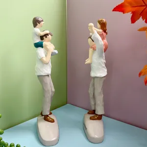 Artistic resin family figurines showing a father carrying a child on his shoulders
