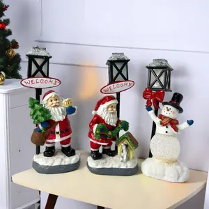 Three-piece glowing Santa Claus and Snowman resin figurines with vintage Welcome street lamps