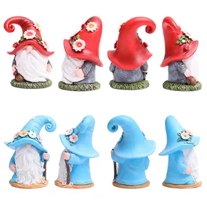 Detailed 360-degree views of resin Christmas gnomes with floral hats and walking sticks