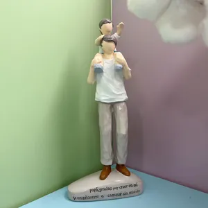 Detailed view of resin father and child figurine with warm hand-carved texture