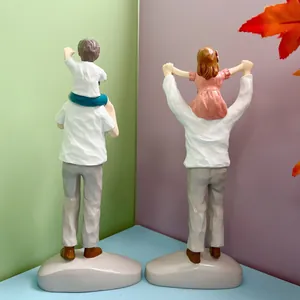 Detailed view of parent-child resin statues showing father carrying children figurines