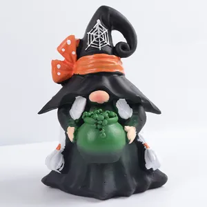 Solar garden gnome witch holding a green cauldron with spider web hat detail