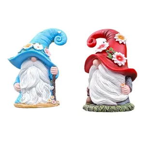 Christmas gnome resin ornaments featuring blue and red garden gnomes with white beards